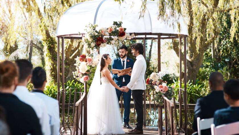 A couple gets married in an outdoor micro wedding venue.