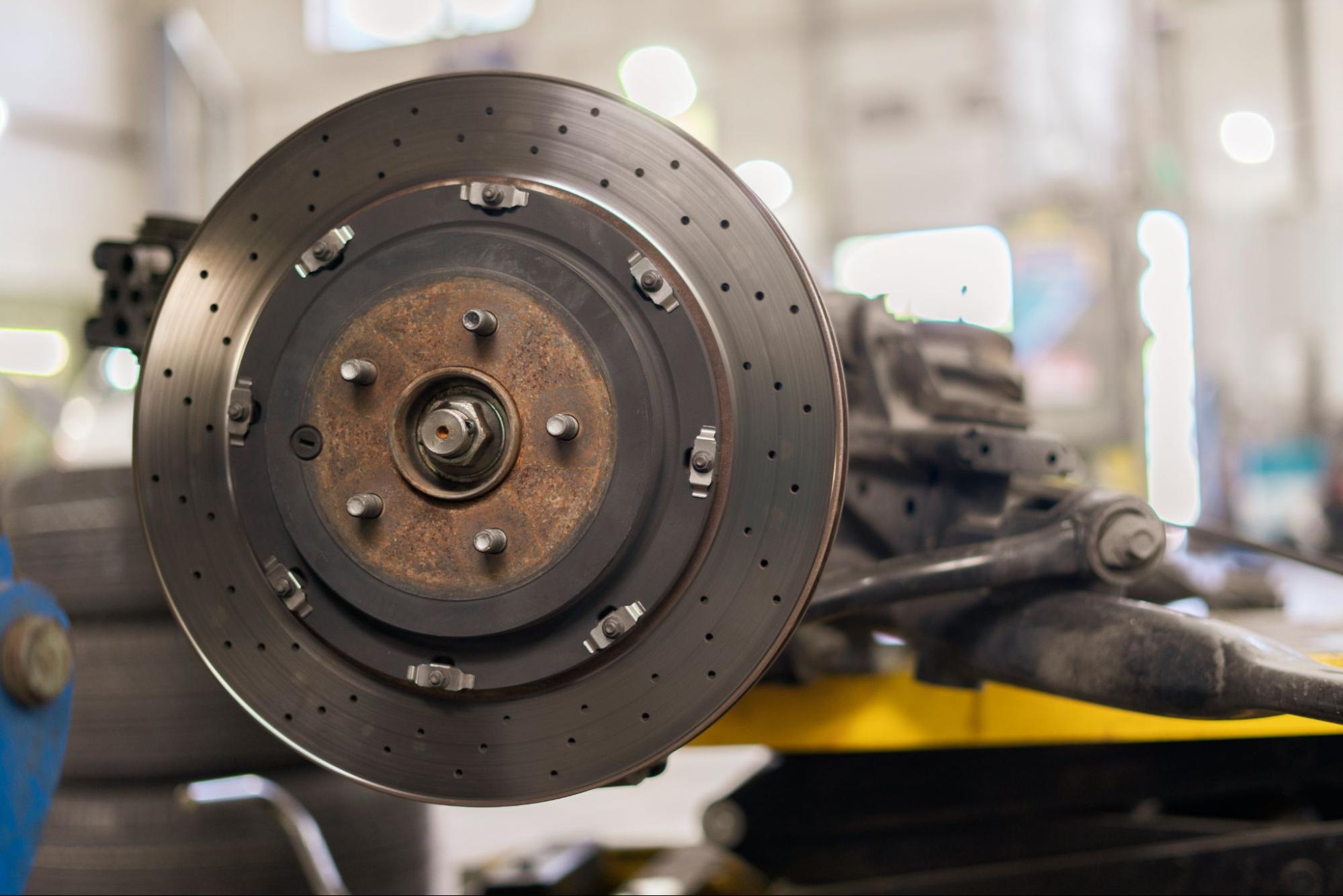 Close-up of a polished chrome brake disc rotor mounted on a vehicle hub